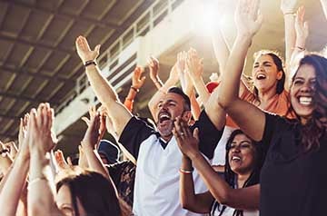 happy people cheering at sports game